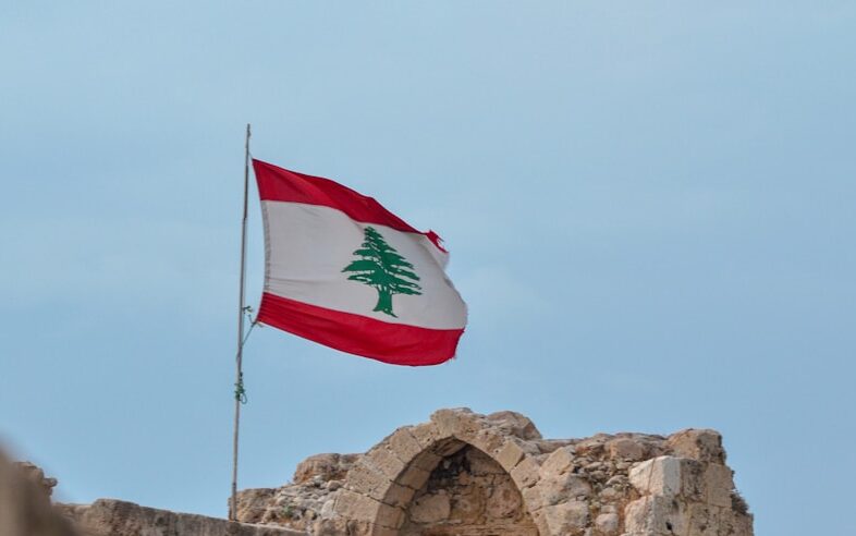 a flag flying on top of a stone structure